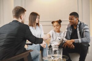 In that image the women , men and their child our Family conflict resolution counseling helps and gave advice
